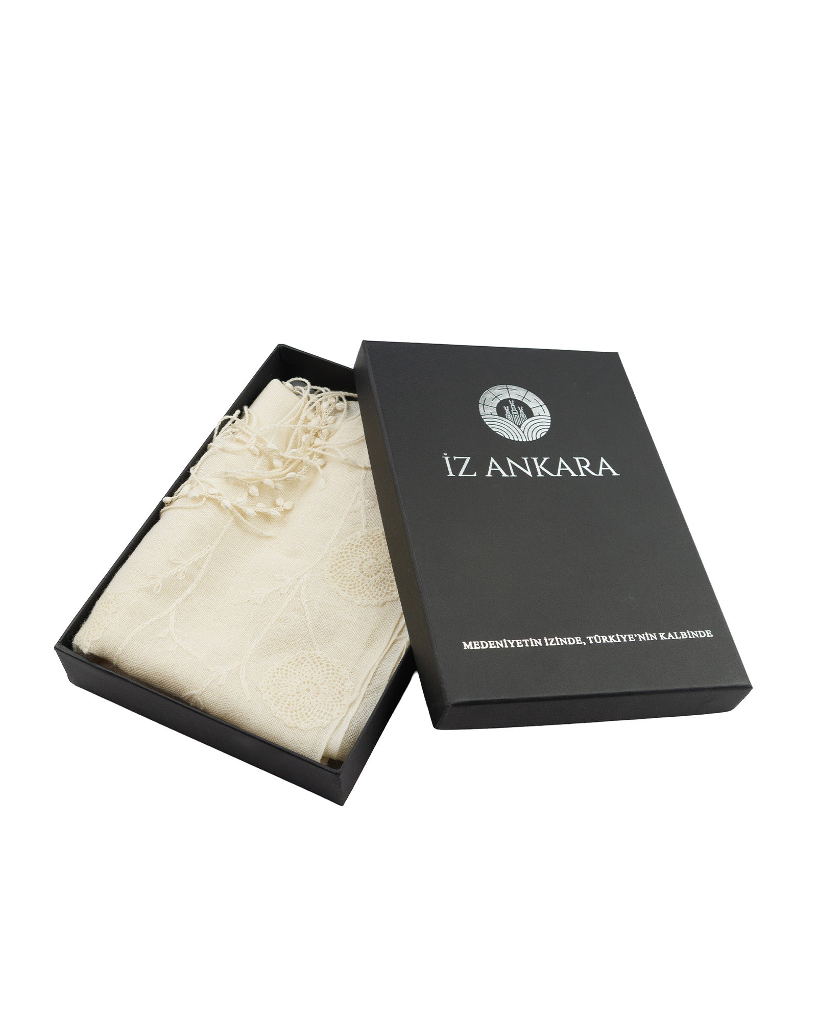 Black box with 'IZ Ankara' branding containing a white fabric item on a white background