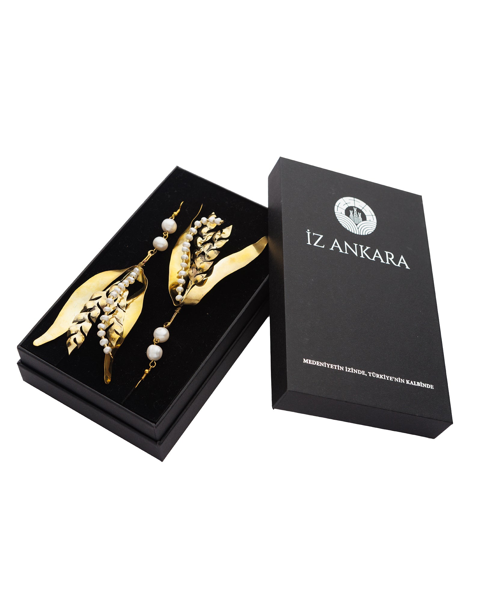 Gold hair pins with pearls in a black box labeled 'Iz Ankara' on a white background