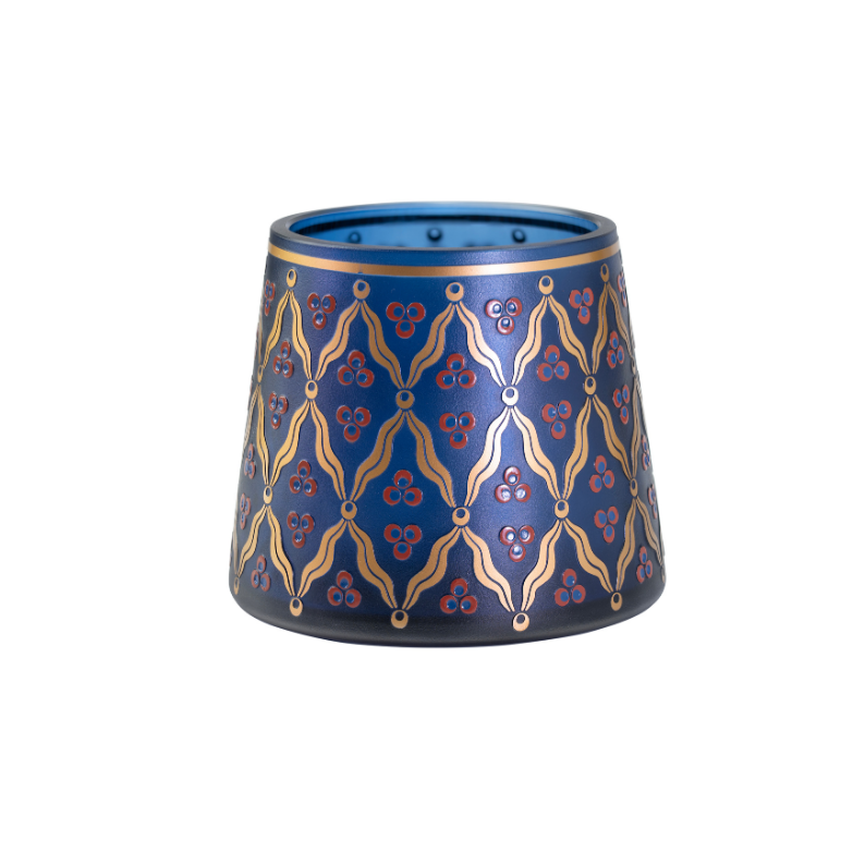 Decorative blue pen holder with gold chintamani patterns on a white background